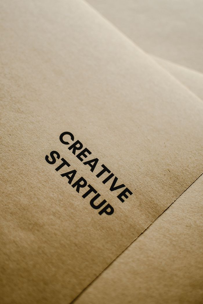 A close-up image of black text Creative Startup on brown paper, highlighting entrepreneurship and innovation.